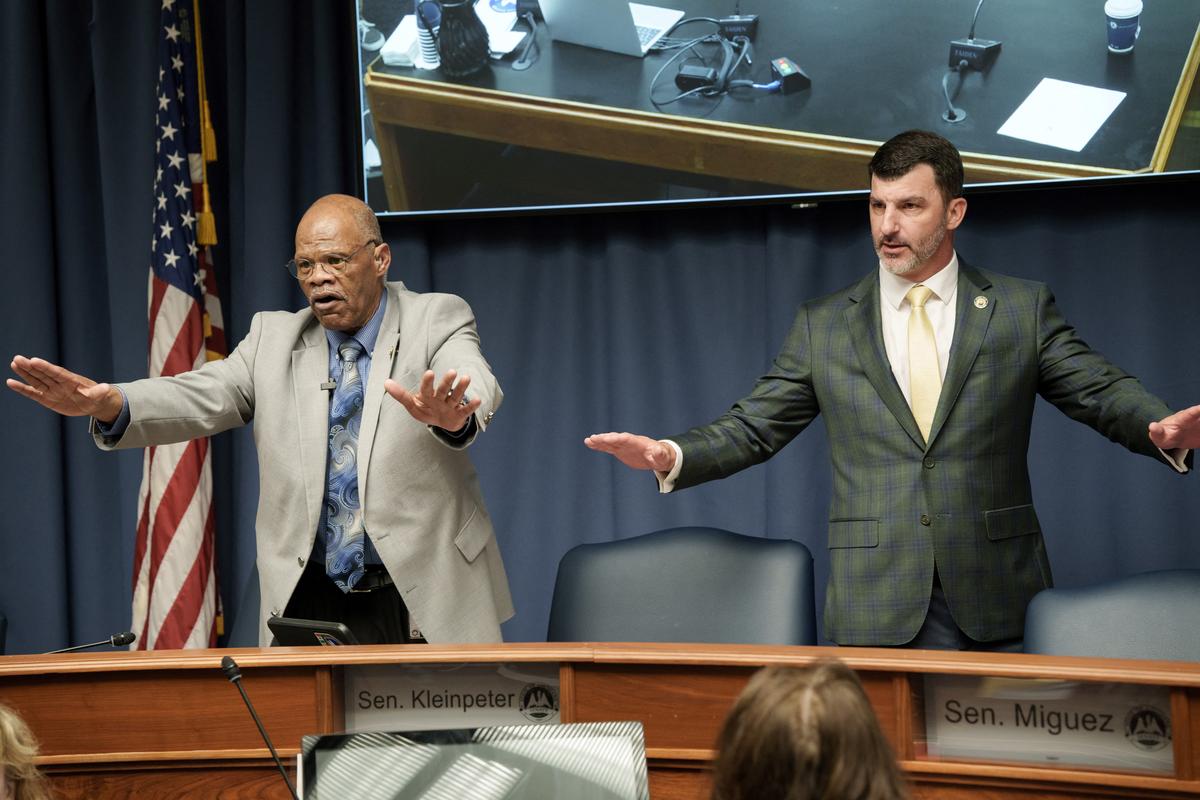 A member of the staff and Louisiana State Senator Caleb S. Kleinpeter try to calm the crowd during a public hearing on redistricting as Louisiana Republicans pursue a new congressional voting map ahead of the November midterm elections, in Baton Rouge, Louisiana, U.S., May 8, 2026. REUTERS/Wayan Barre