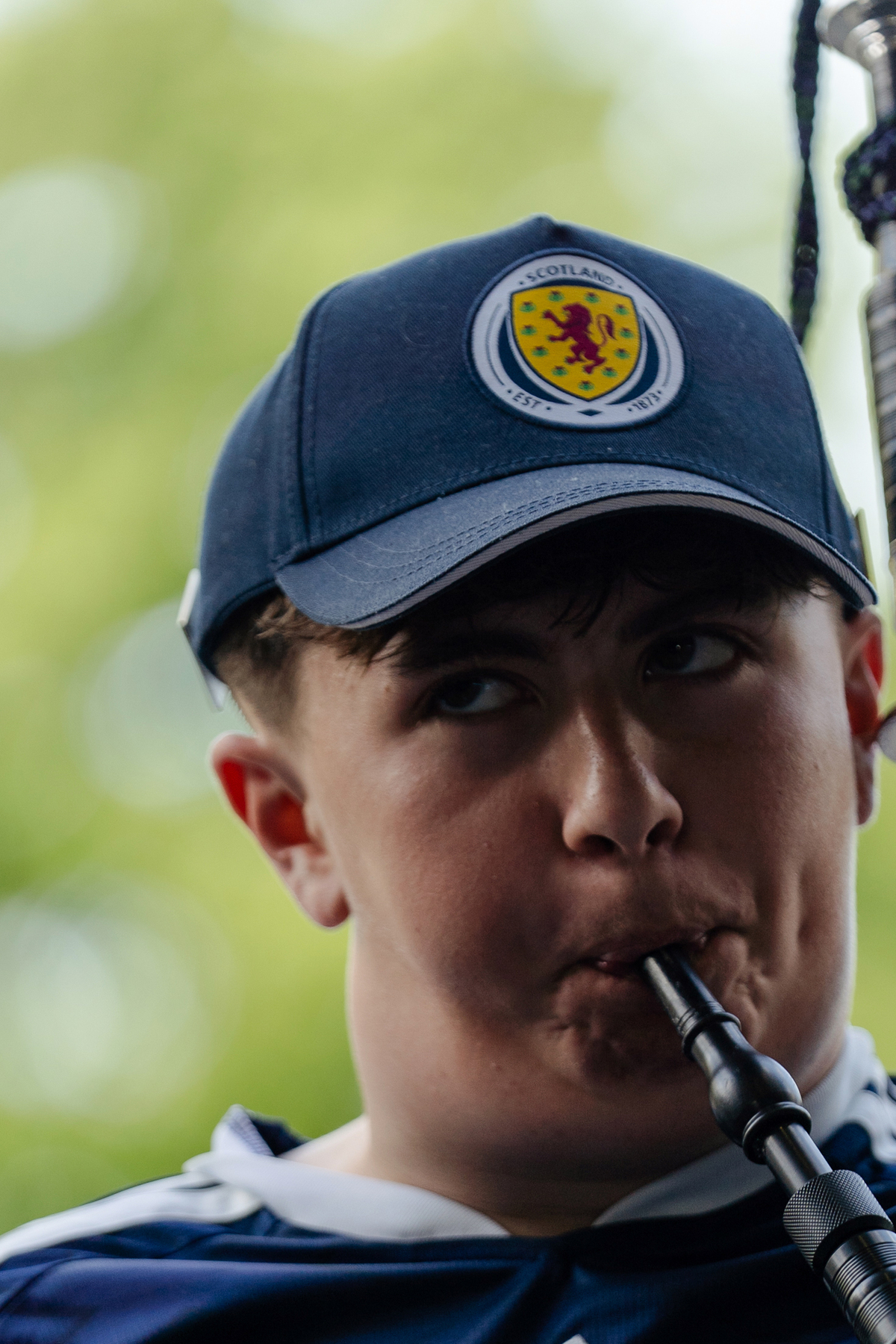 A member of the Bagpipe Bros plays outside The Dubliner Irish pub in Boston on June 17, 2026. The Tartan Army -- thousands of soccer fans from Scotland, here to see their national team play outside Boston in two matches of the World Cup -- are packing this old city's narrow streets, its subway cars, restaurants and pubs, and filling the air with the cry of bagpipes. (Sophie Park/The New York Times)