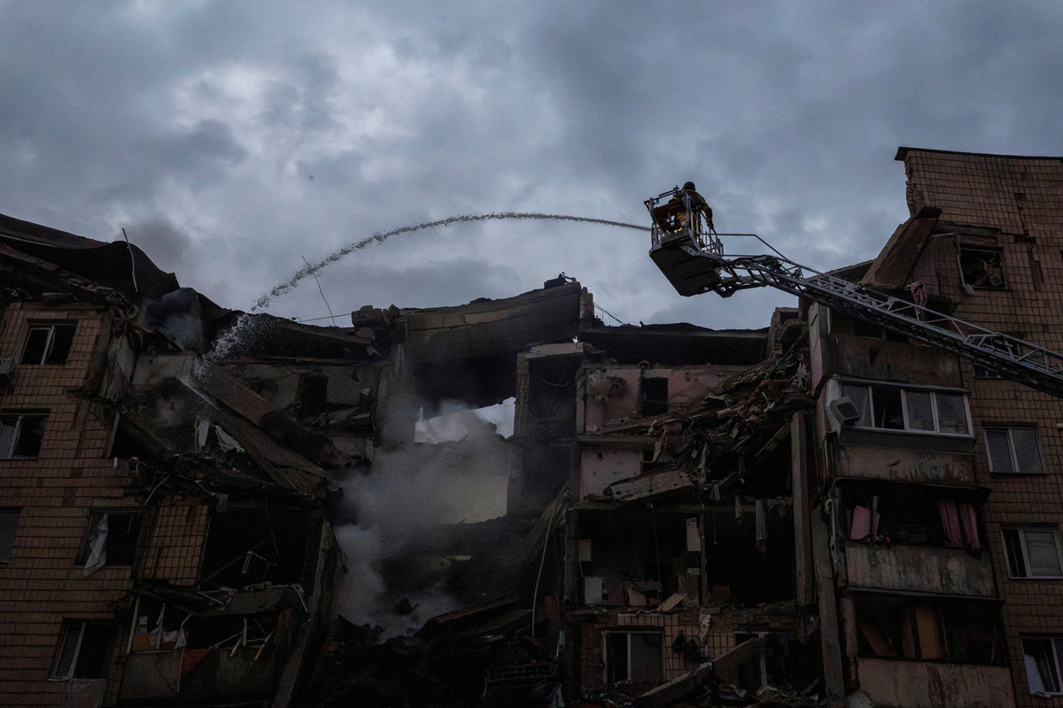 Emergency services work at the site of an apartment building, which  was heavily damaged during Russian missile and drone strikes, amid Russia's attack on Ukraine, in Kyiv, Ukraine July 6, 2026. REUTERS/Thomas Peter