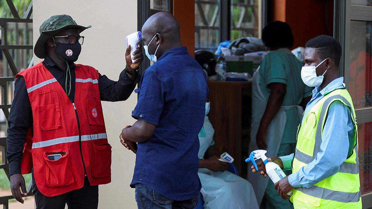 A member of the Uganda Red Cross checks the temperature of the faithful attending the Martyrs’ Day Mass at the Basilica of the Uganda Martyrs in Namugongo, as authorities intensify efforts to contain a new Ebola outbreak, on Wednesday. The World Health Organization said that the world is “catching up” with the Ebola outbreak in the Democratic Republic of Congo, although challenges still remain.