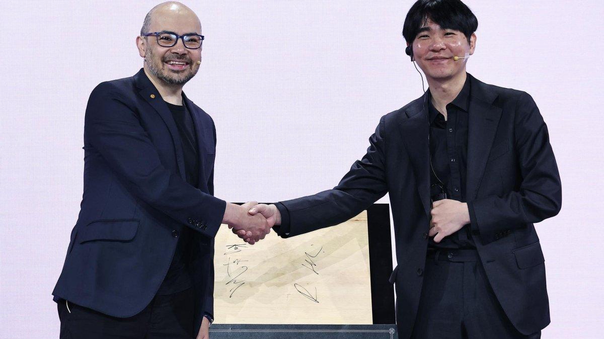 Demis Hassabis, the co-founder and chief executive officer of Google DeepMind (L), shakes hands with South Korea's legendary Go player Lee Sedol at an event held in Seoul on Wednesday. Photo by Yonhap