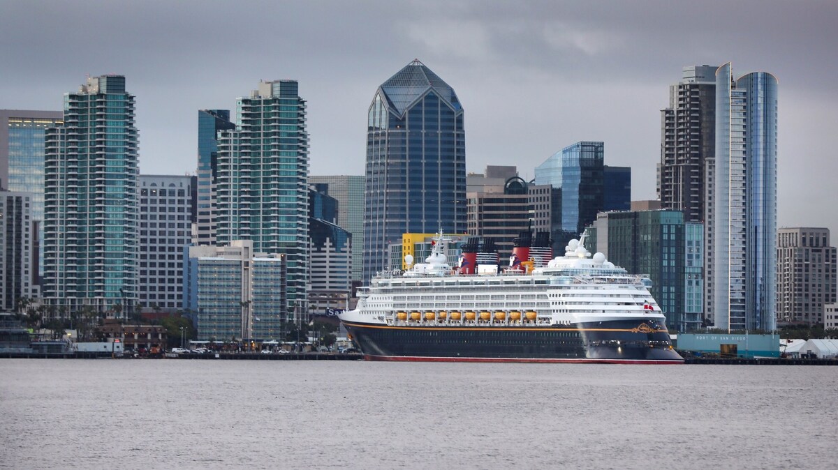 With the downtown San Diego skyline as a backdrop, the cruise ship Disney Wonder, docked at the B Street Pier on Embarcadero, is seen on Thursday morning, March 19, 2020, in San Diego, California. (Howard Lipin/The San Diego Union-Tribune/TNS)