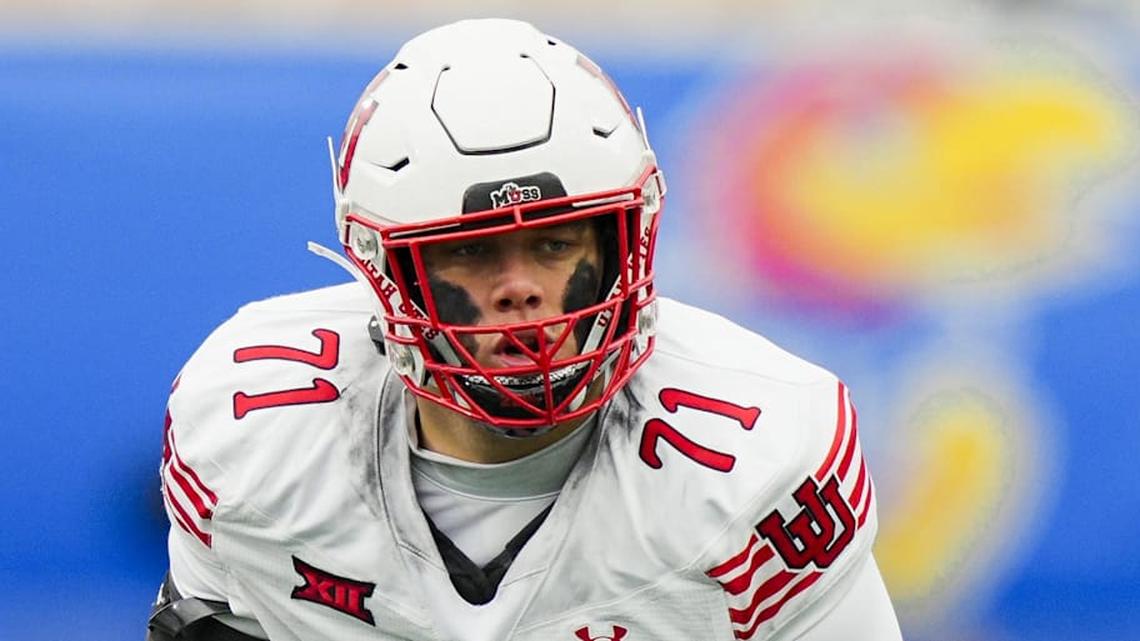  Nov 28, 2025; Lawrence, Kansas, USA; Utah Utes offensive lineman Caleb Lomu (71) gets ready before the snap during the second half against the Kansas Jayhawks at David Booth Kansas Memorial Stadium. Mandatory Credit: Jay Biggerstaff-Imagn Images | Jay Biggerstaff-Imagn Images 