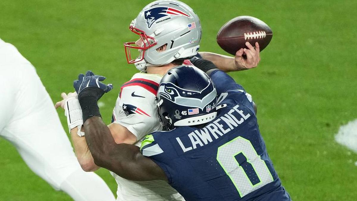  Feb 8, 2026; Santa Clara, CA, USA; New England Patriots quarterback Drake Maye (10) is hit as he throws by Seattle Seahawks defensive end DeMarcus Lawrence (0) in the second half in Super Bowl LX at Levi's Stadium. Mandatory Credit: Kirby Lee-Imagn Images | Kirby Lee-Imagn Images 