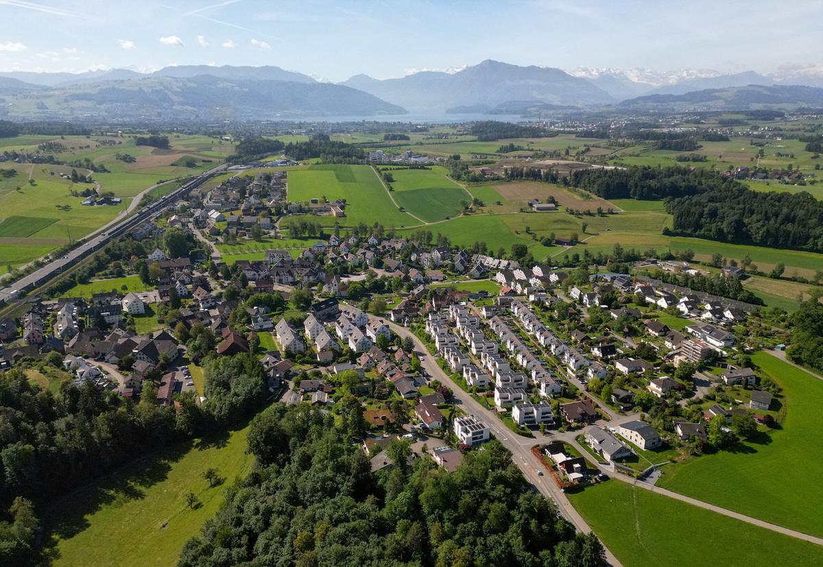 A drone view shows newly constructed dwellings in the village of Knonau, ahead of a June 14 vote on a plan backed by the right-wing Swiss People's Party (SVP) to curb population growth to 10 million inhabitants, in Knonau, Switzerland, May 21, 2026. REUTERS/Cecile Mantovani