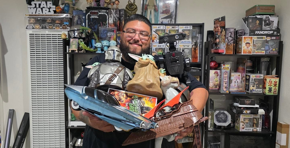 Jonathan Jovel, a Star Wars content creator known online as The Jedi Collector, poses with a variety of popcorn buckets in his home in Anaheim, California.