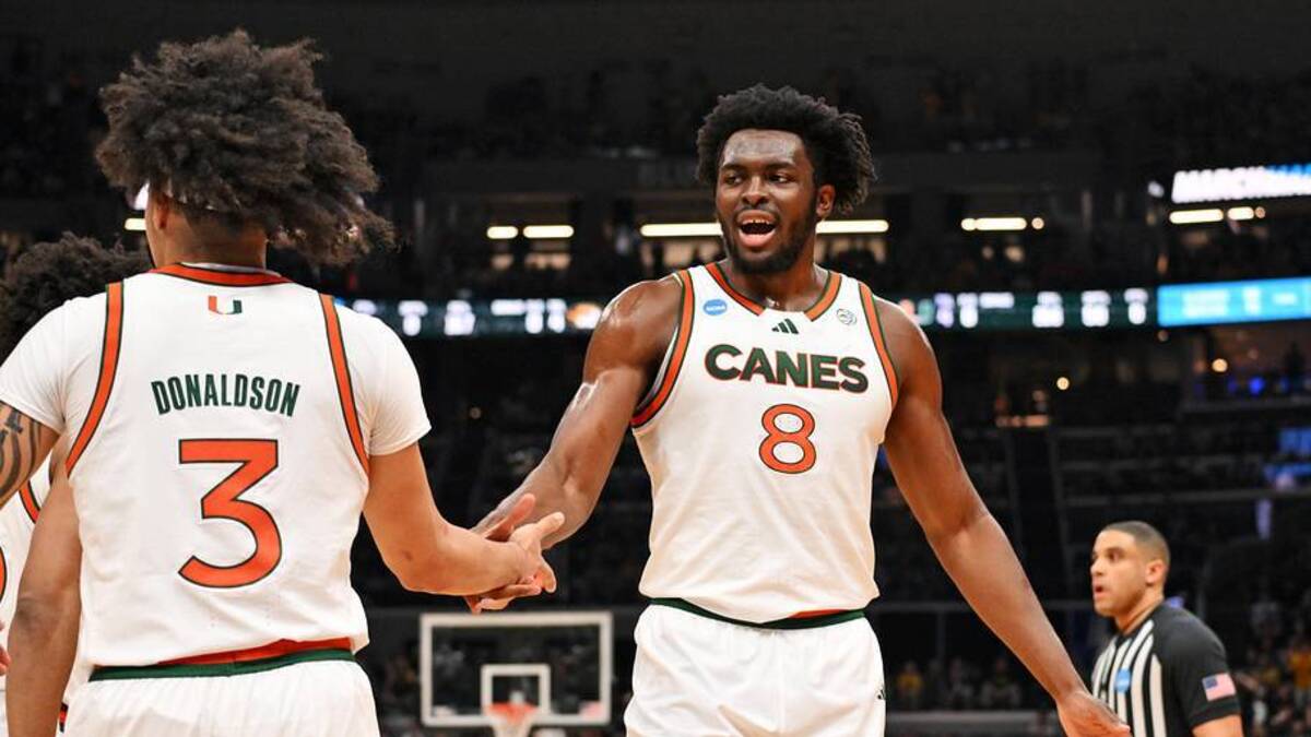  Mar 20, 2026; St. Louis, MO, USA; Miami (FL) Hurricanes center Ernest Udeh Jr. (8) and Miami (FL) Hurricanes guard Tre Donaldson (3) react after a play during the first half against the Missouri Tigers during a first round game of the men's 2026 NCAA Tournament at Enterprise Center. Mandatory Credit: Jeff Curry-Imagn Images | Jeff Curry-Imagn Images 