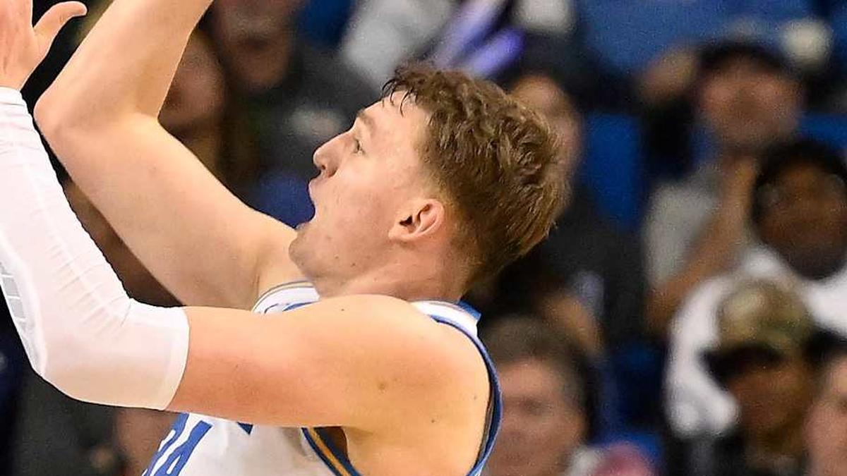  Feb 21, 2026; Los Angeles, California, USA; UCLA forward Tyler Bilodeau (34) shoots over Illinois guard Kylan Boswell (4) and Illinois center Zvonimir Ivisic (44) during overtime at Pauley Pavilion presented by Wescom Financial. Mandatory Credit: Robert Hanashiro-Imagn Images | Robert Hanashiro-Imagn Images 
