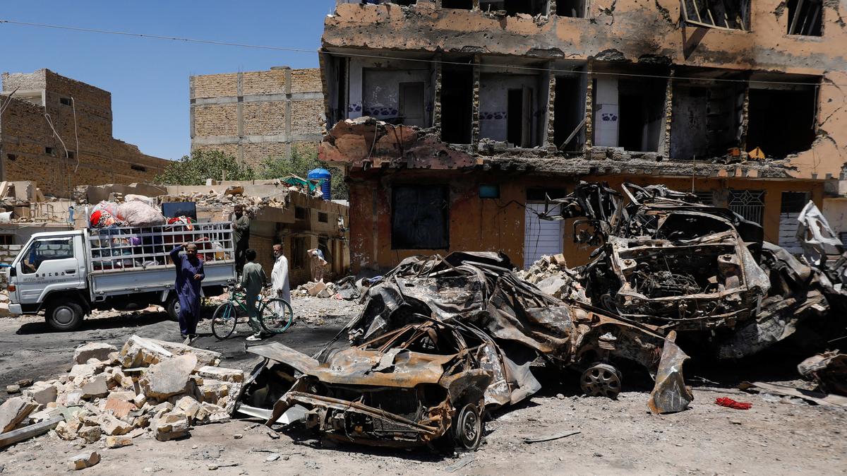 Residents stand next to a damaged building, rubble and destroyed cars a day after a blast in Quetta, Pakistan May 25, 2026. REUTERS/Naseer Ahmed