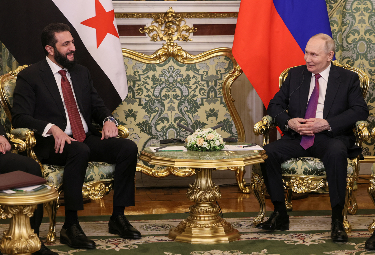 FILE PHOTO: Russian President Vladimir Putin (R) smiles speaking with Syrian President Ahmed al-Sharaa during their meeting at the Kremlin in Moscow, Russia, 28 January 2026.    MAXIM SHIPENKOV/Pool via REUTERS/File Photo