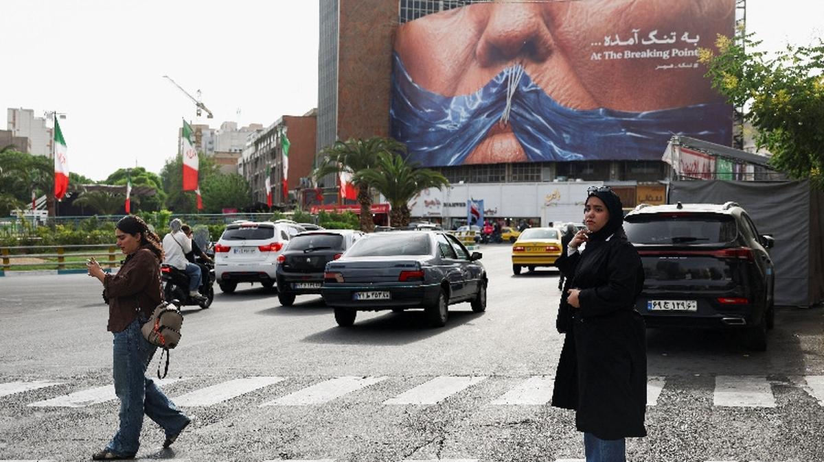 A woman walks past an anti-U.S. billboard depicting U.S. President Donald Trump and the Strait of Hormuz, in Tehran, Iran, May 17, 2026. Majid Asgaripour/WANA (West Asia News Agency) via REUTERS