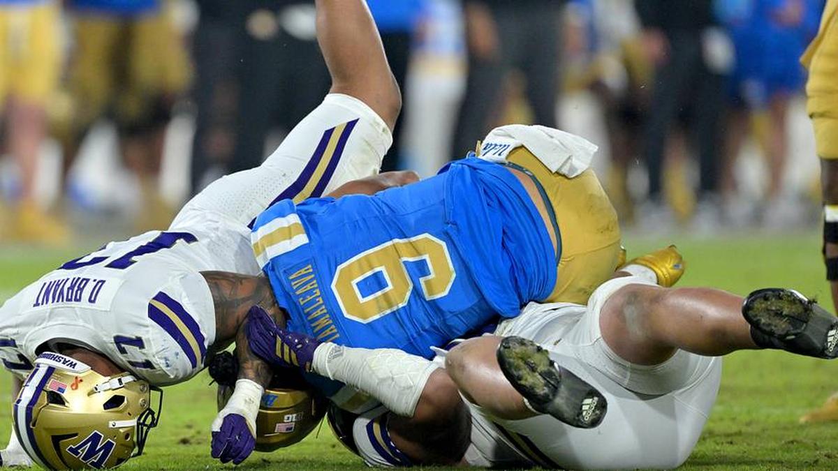  Nov 22, 2025; Pasadena, California, USA; UCLA Bruins quarterback Nico Iamaleava (9) is sacked by Washington Huskies linebacker Deven Bryant (17) and defensive lineman Bryce Butler (92) during the second half at the Rose Bowl. Mandatory Credit: Jayne Kamin-Oncea-Imagn Images | Jayne Kamin-Oncea-Imagn Images 