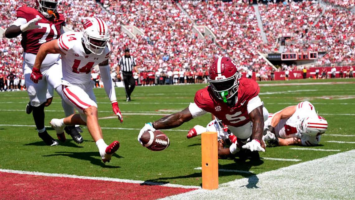  Sep 13, 2025; Tuscaloosa, Alabama, USA; Alabama wide receiver Germie Bernard (5) dives for a score at the pylon with Wisconsin defensive back Preston Zachman (14), Wisconsin defensive back D'Yoni Hill (5) and Wisconsin linebacker Tackett Curtis (4) unable to make the stop at Saban Field at Bryant-Denny Stadium. Mandatory Credit: Gary Cosby Jr.-Imagn Images | Gary Cosby Jr. / USA TODAY NETWORK via Imagn Images 