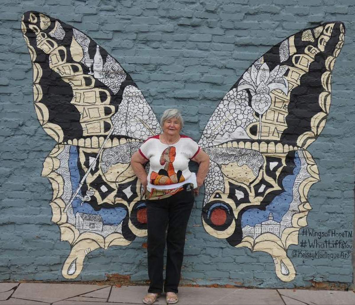  Author poses at The Wings of Hope mural in a pocket park in downtown Maryville. Photo credit: Kathleen Walls 