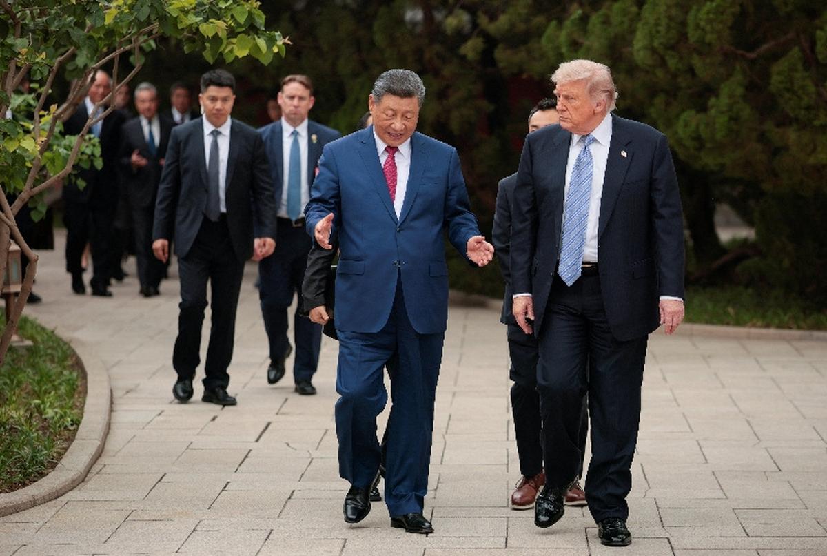 U.S. President Donald Trump walks with Chinese President Xi Jinping while leaving after a visit to the Zhongnanhai Garden in Beijing, China, May 15, 2026. REUTERS/Evan Vucci/Pool