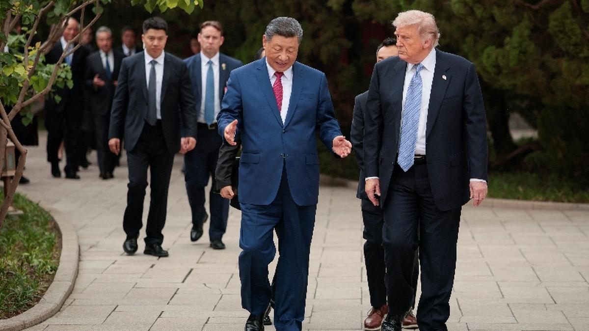 U.S. President Donald Trump walks with Chinese President Xi Jinping while leaving after a visit to the Zhongnanhai Garden in Beijing, China, May 15, 2026. REUTERS/Evan Vucci/Pool
