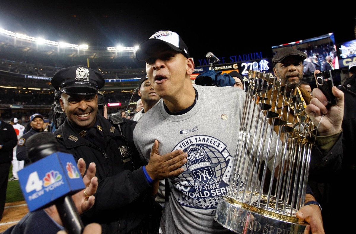  New York Yankees third baseman Alex Rodriguez carries the World Series trophy off the field after the 2009 World Series at Yankee Stadium. Jerry Lai-USA TODAY Sports