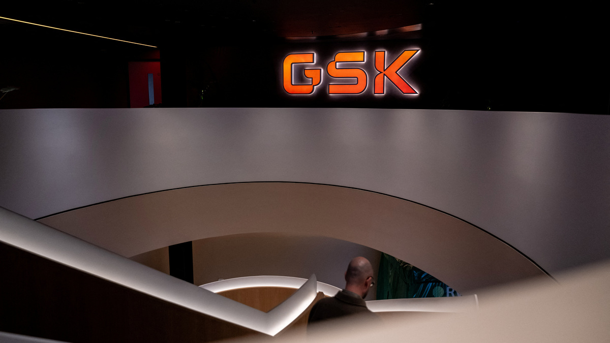A staff member walks down stairs in the main lobby of GSK offices in London, Britain, February 20, 2025. REUTERS/Chris J. Ratcliffe