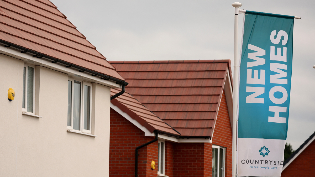 A banner advertising new houses for sale a seen on a new housing development under construction in Partington, Britain June 1, 2023. REUTERS/Phil Noble