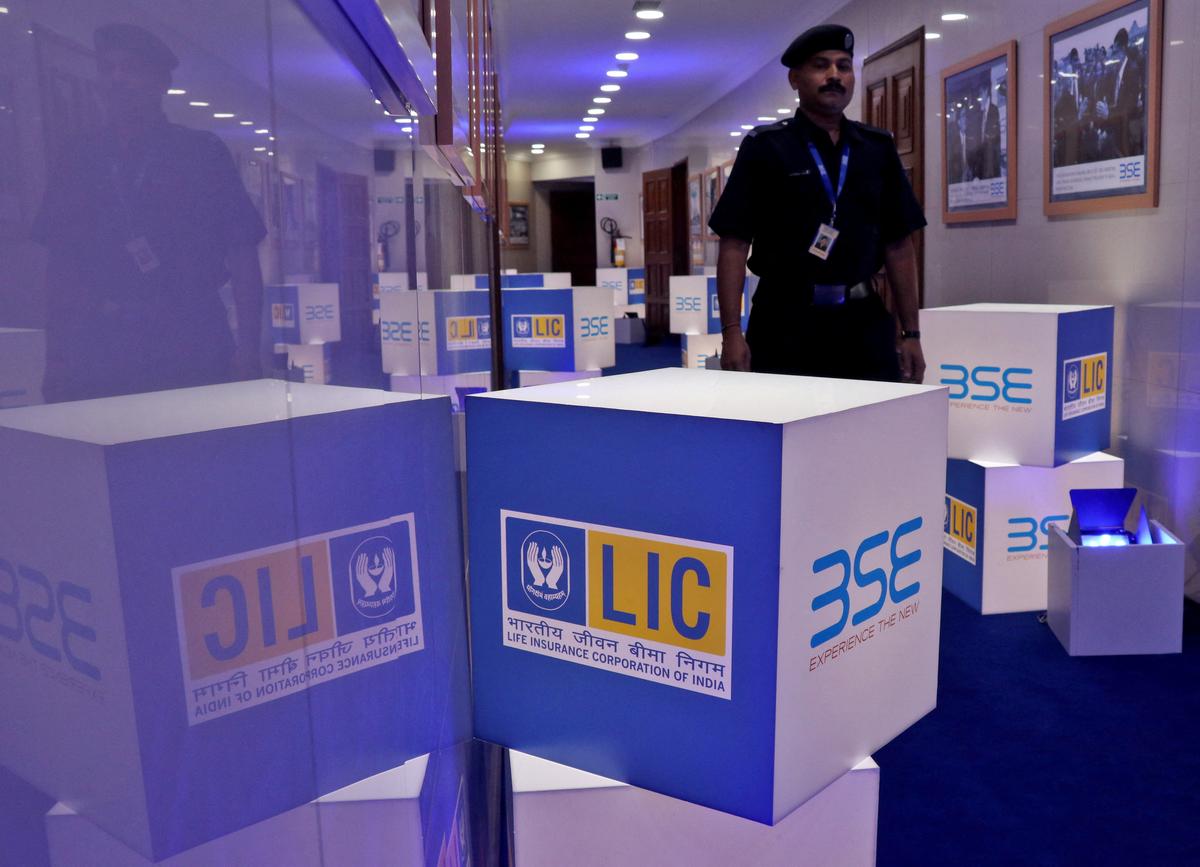FILE PHOTO: A security guard walks past logos of Life Insurance Corporation of India (LIC) and Bombay Stock Exchange (BSE) inside the BSE building in Mumbai, India, May 17, 2022. REUTERS/Niharika Kulkarni/File Photo
