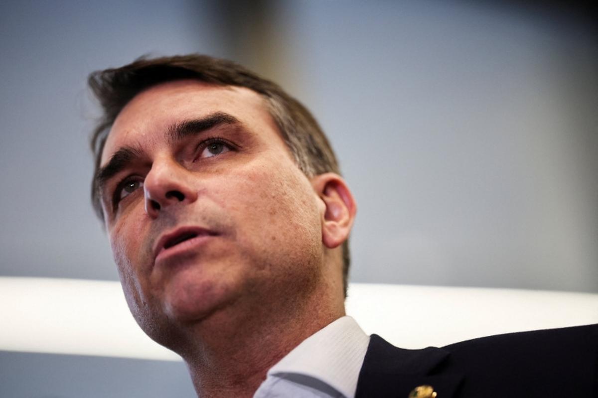 Flavio Bolsonaro speaks with members of the press after a meeting, following a scandal over messages tied to his request for funding for a biopic about former Brazilian President Jair Bolsonaro, from disgraced banker Daniel Vorcaro, who was arrested in March on suspicion of leading a multibillion-dollar fraud scheme, in Brasilia, Brazil, May 19, 2026. REUTERS/Mateus Bonomi