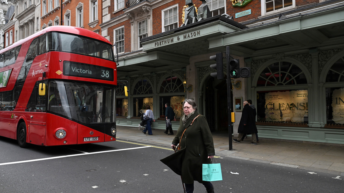A woman walks outside Fortum and Mason on Piccadilly as British retail sales fell in February after the strongest growth in a year and a half in January, official figures showed on Friday, as higher oil prices caused by the Iran war sap households' disposable income, in London, Britain, March 27, 2026. REUTERS/Jaimi Joy