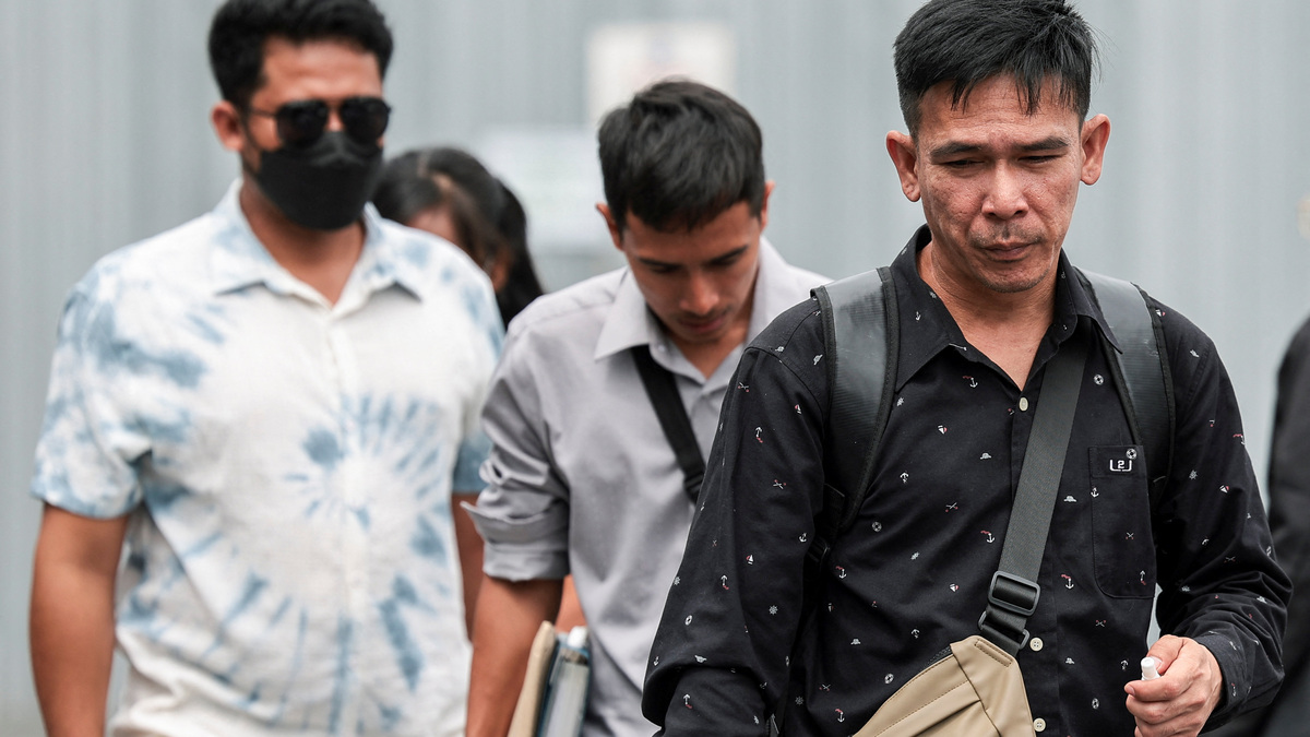 Panithi Tumkaew, 43, Noppadon Wongsuvan, 33, and Surades Manpuen, 32, Thai crew members of the cargo ship Mayuree Naree that was struck on March 11, killing three crew members, while sailing through the Strait of Hormuz, walk after the Central Labour Court accepts a lawsuit accusing Thailand-based company Precious Shipping of ordering the vessel to sail through the waterway despite military tensions between the U.S. and Iran, in Bangkok, Thailand, July 10, 2026. REUTERS/Chalinee Thirasupa