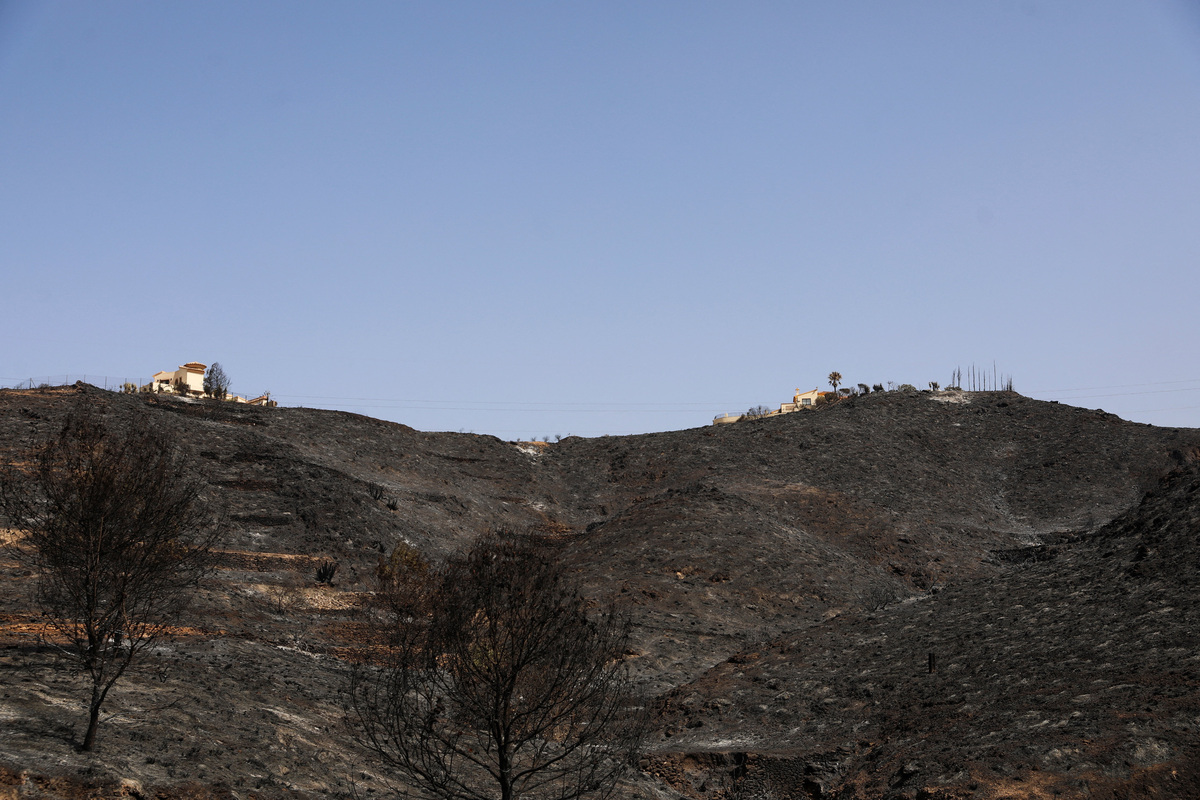 Houses remain amidst a burned area following deadly wildfires affecting Almeria province, in Bedar, Almeria, Spain, July 11, 2026. REUTERS/Loyola Perez de Villegas Muniz