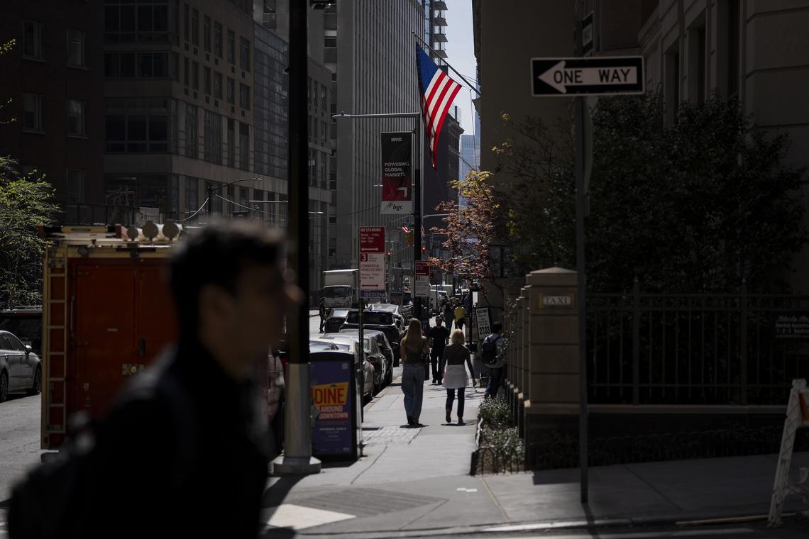 **EMBARGO: No electronic distribution, Web posting or street sales before MONDAY 5:01 A.M. ET APRIL 27, 2026. No exceptions for any reasons. EMBARGO set by source.** FILE -- An American flag hangs from an office building in Manhattan, April 16, 2026. Banks in the United States have lowered their growth forecasts and raised inflation outlooks. (Vincent Alban/The New York Times)