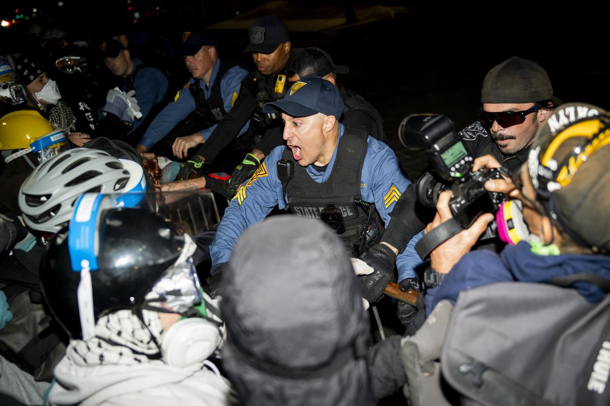 Demonstrators and police officers outside the Delaney Hall immigration detention center in Newark, N.J., May 30, 2026. Mayor Ras Baraka of Newark imposed a curfew early Sunday around the immigration detention center after a second consecutive night of unrest over living conditions there. (Vincent Alban/The New York Times)