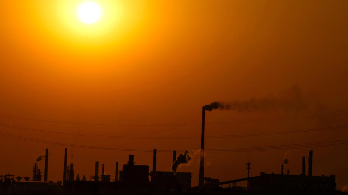 FILE PHOTO: FILE PHOTO: Factories are silhouetted during sunset, in Handan, Hebei province, China April 7, 2026. REUTERS/Tingshu Wang