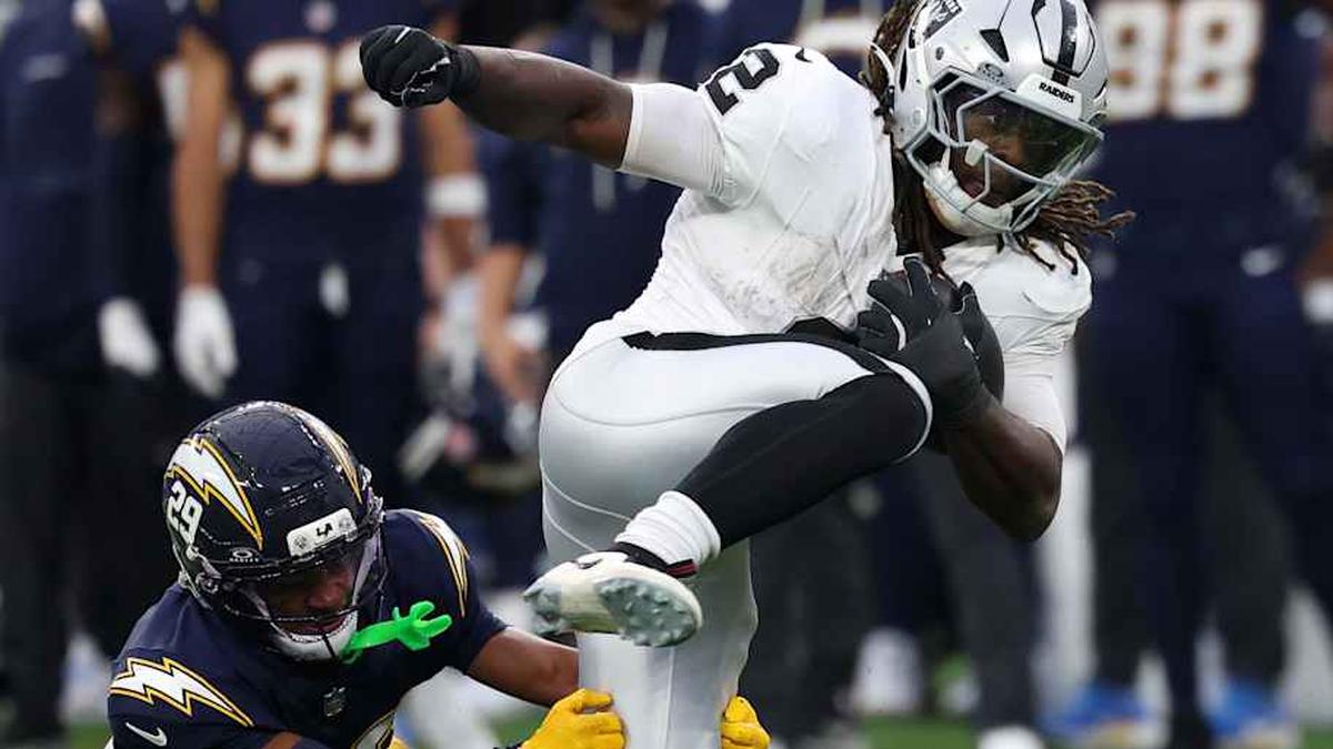  Nov 30, 2025; Inglewood, California, USA; Las Vegas Raiders running back Ashton Jeanty (2) rushes the ball past Los Angeles Chargers cornerback Tarheeb Still (29) during the second half at SoFi Stadium. Mandatory Credit: Kiyoshi Mio-Imagn Images | Kiyoshi Mio-Imagn Images 