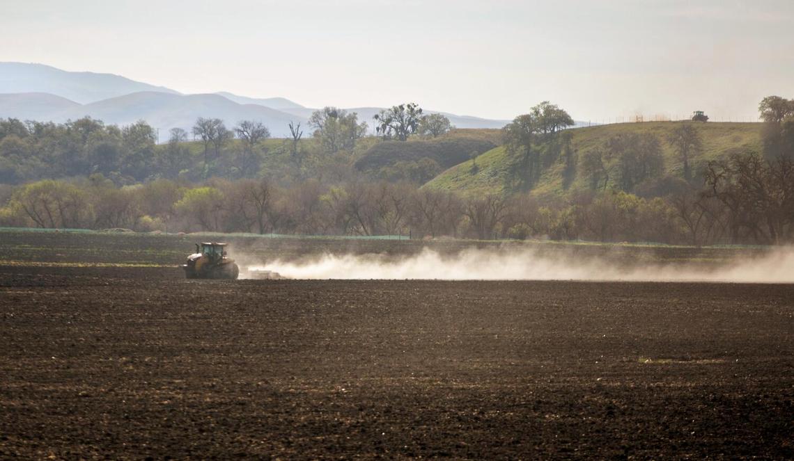 A tractor plows a field on Tuesday, March 22, 2022 in Paso Robles, CA. {({photographer} / Los Angeles Times)