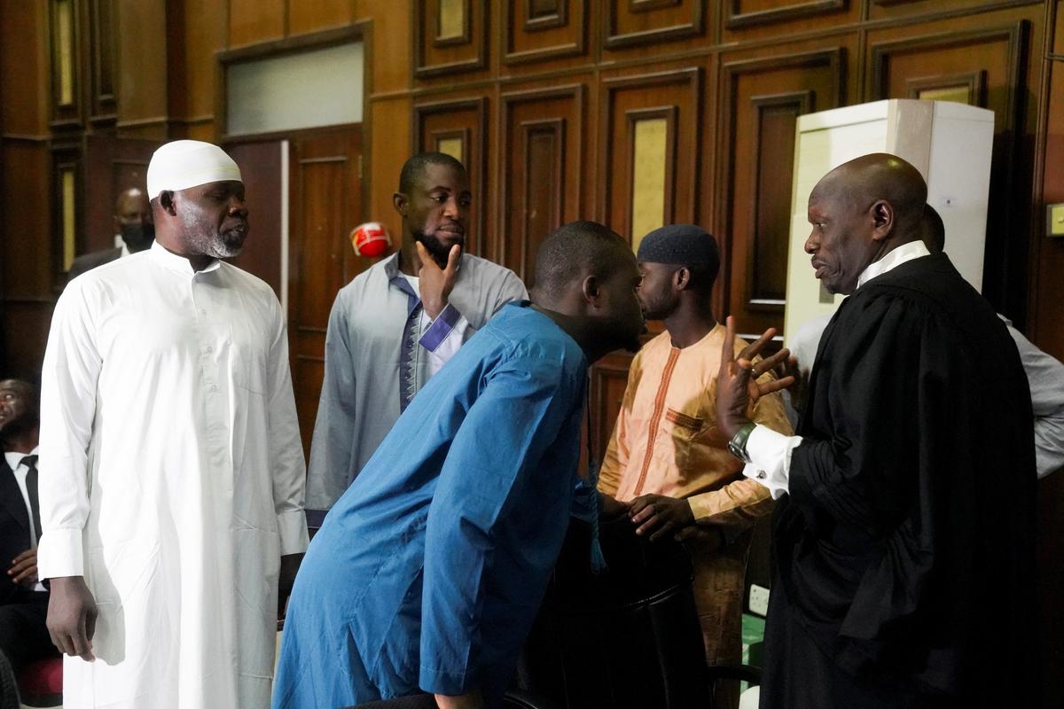 Suspects accused of involvement in the June 5, 2022 attack on St. Francis Catholic Church in Owo, Ondo State, speak with their lawyer at the Federal High Court ahead of judgment in Abuja, Nigeria, June 3, 2026. REUTERS/Marvellous Durowaiye