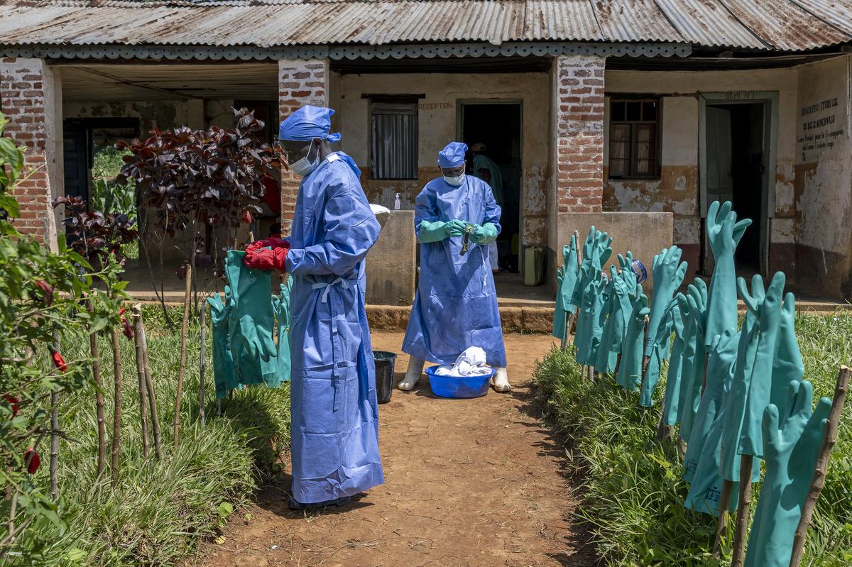 Health workers hang protective gloves to dry after washing them for reuse at Mongbwalu General Hospital in Mongbwalu, which is at the epicenter of the Ebola virus outbreak in Democratic Republic of Congo, May 25, 2026. In a remote gold mining town at the epicenter of the Ebola outbreak, medical workers struggle to beat back a surge of deaths and infections. (Arlette Bashizi/The New York Times)