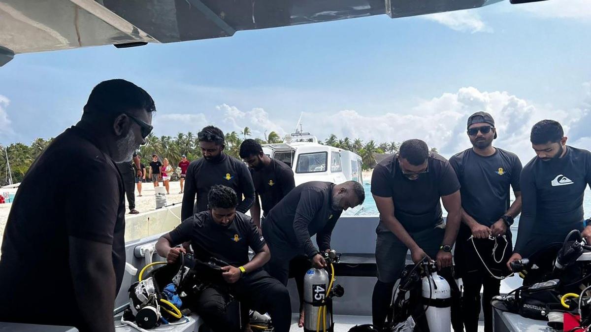 Maldives National Defense Force military divers prepare to enter the water on Saturday amid a search for four Italian divers missing off the Vaavu Atoll. Staff Sergeant Mohammed Mahdi (2-L) was killed later the same day after sustaining decompression injuries, bringing the total death toll in the incident to six. Photo by Maldives President's Media Division/EPA