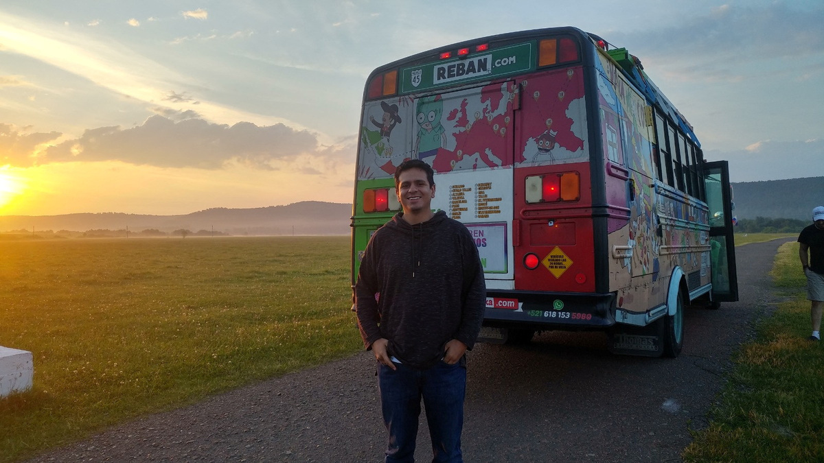 Eduardo Marin, who was born in 1986, the last time Mexico hosted a World Cup, poses for a photo next to a bus painted by him and his friends, including parts painted in the colours of Mexico's flag - green, white and red, which they drove across Europe to follow their national team during the 2018 World Cup in Russia, in Rostov, Russia, June 25, 2018. Eduardo Marin/Handout via REUTERS