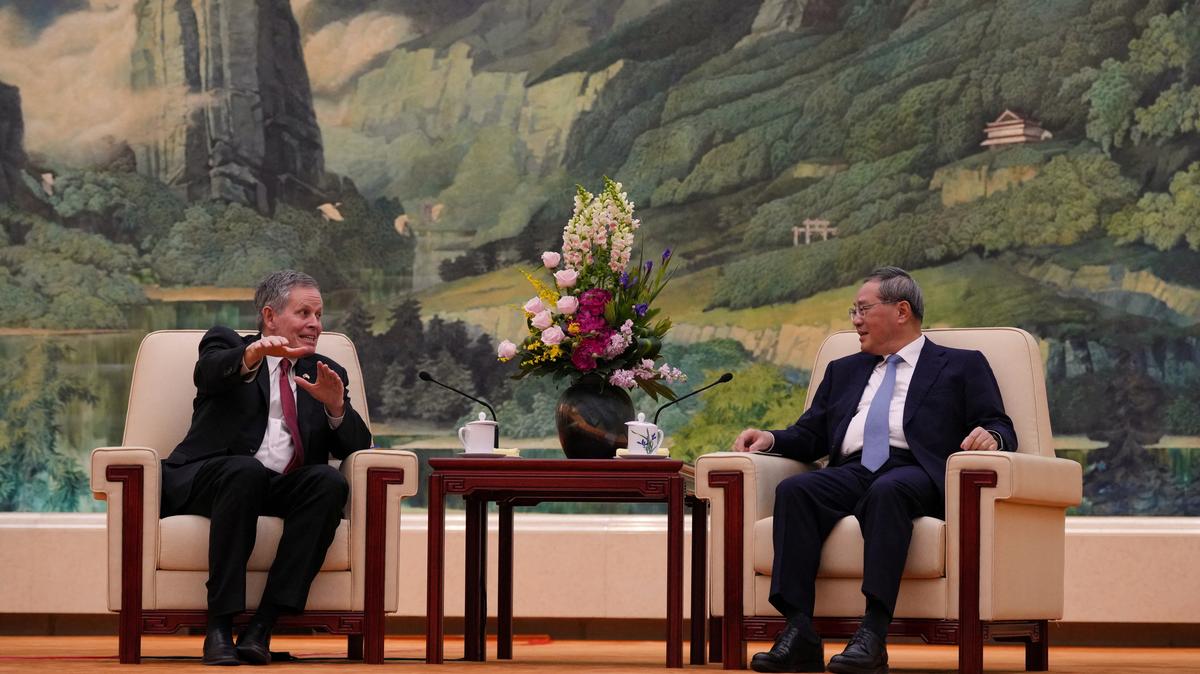 U.S. Senator Steve Daines, left, talks to Chinese Premier Li Qiang during a meeting at the Great Hall of the People, in Beijing, Thursday, May 7, 2026.     Andy Wong/Pool via REUTERS