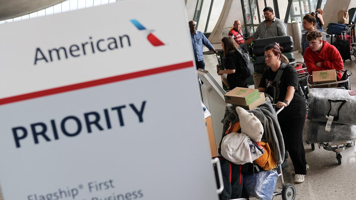 People from the first group of white South Africans granted refugee status for being deemed victims of racial discrimination under U.S. President Trump's Refugee plan, check in for a connecting flight, at Dulles International Airport, in Dulles, Virginia, U.S., May 12, 2025. REUTERS/Jonathan Ernst