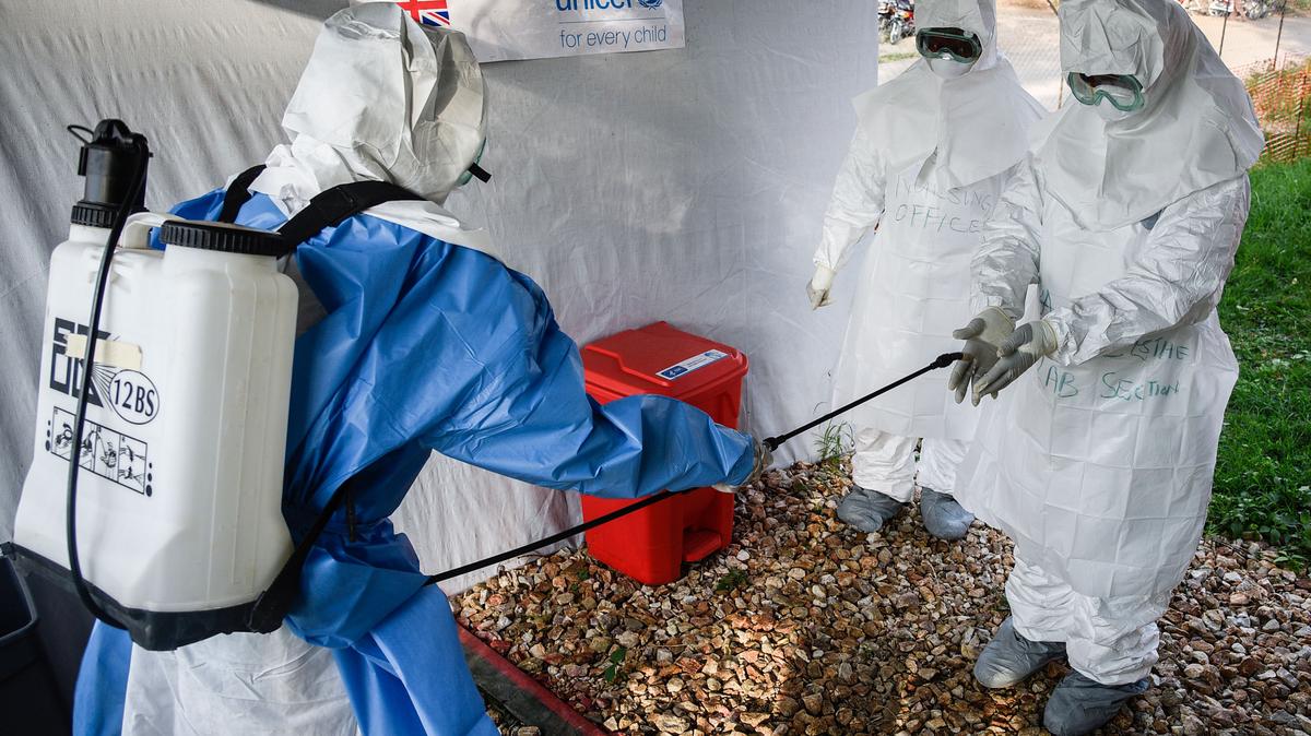 In this photo from December 12, 2018, the medical staff of the Ebola Treatment Unit (ETU) get ready to work in their Personal Protective Equipment (PPE) during their weekly rehearsal at the Bwera General Hospital in Bwera bordering DRC, western Uganda. (Isaac Kasamani/AFP via Getty Images/TNS)