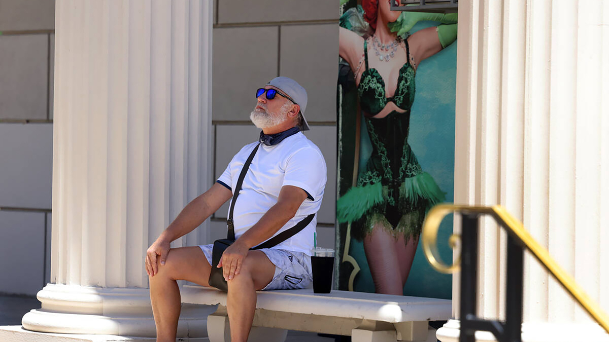 A weary tourist takes a quiet break, sitting under a shady rest area near Caesars Palace on June 17, 2026, in Las Vegas. (Bizuayehu Tesfaye/Las Vegas Review-Journal/TNS)