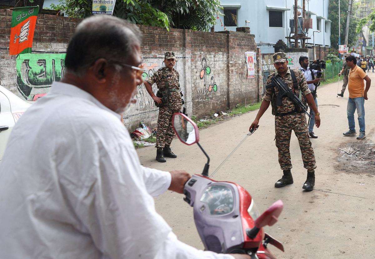 Members of security forces stop vehicles as they stand guard along a road leading to the site where an aide of Suvendu Adhikari, a leader of Bharatiya Janata Party (BJP) in West Bengal state, was shot dead days after the BJP secured a majority in the state assembly elections, in North 24 Parganas, on the outskirts of Kolkata, India, May 7, 2026. REUTERS/Sahiba Chawdhary