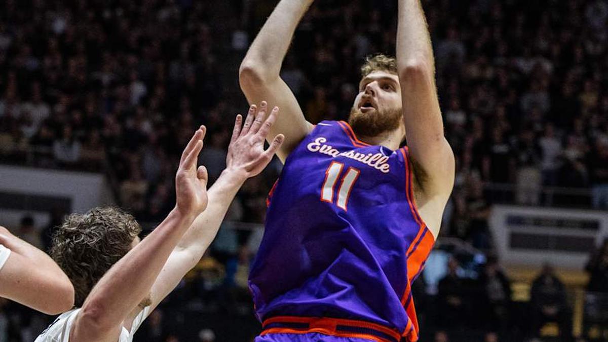  Nov 4, 2025; West Lafayette, Indiana, USA; Evansville Purple Aces forward Joshua Hughes (11) shoots the ball while Purdue Boilermakers forward Trey Kaufman-Renn (4) defends in the first half at Mackey Arena. Mandatory Credit: Trevor Ruszkowski-Imagn Images | Trevor Ruszkowski-Imagn Images 