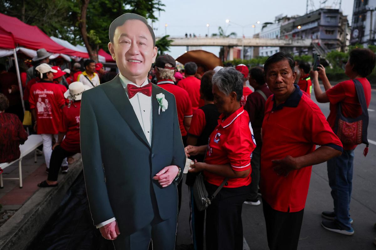 Supporters of former Thai Prime Minister Thaksin Shinawatra wait for his release on parole after serving eight months of his one-year sentence at Klong Prem Central Prison, in Bangkok, Thailand, May 11, 2026. REUTERS/Athit Perawongmetha