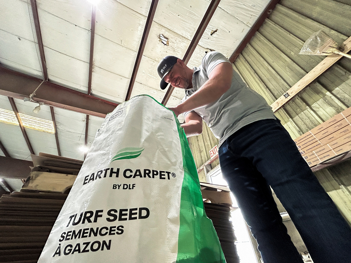 Tom Rinn of global grass seed giant DLF checks out a bag of turf grass in his company's facility in Winnipeg, Manitoba, Canada, May 25, 2026. REUTERS/Ed White