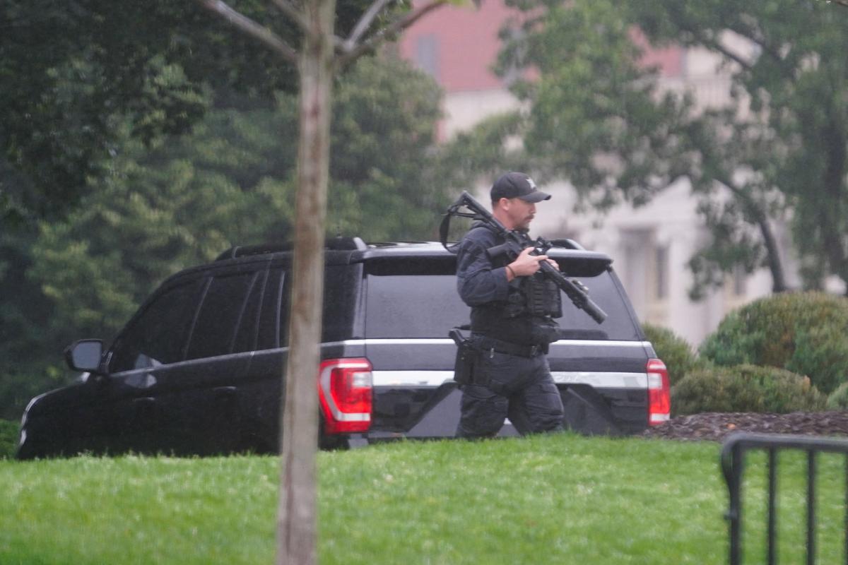 A U.S. Secret Service agent walks holding his weapon after alleged gunshots were heard nearby, at the White House in Washington, D.C., U.S., May 23, 2026. REUTERS/Nathan Howard