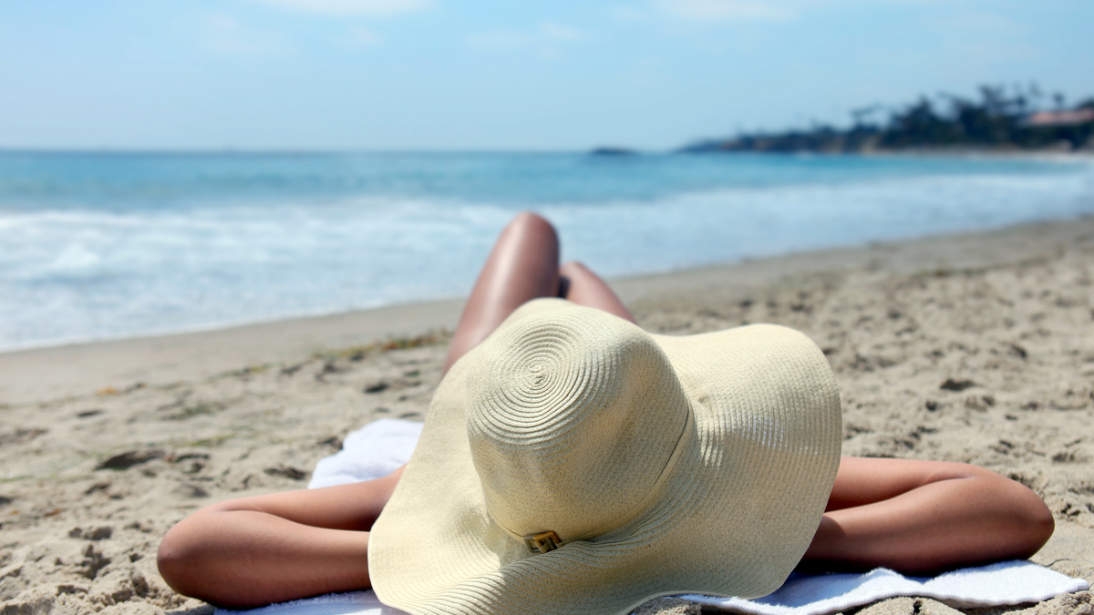 “Tanfluencers” widely share popular videos of extreme tanning methods and media monitor weather reports for maximum ultraviolet exposure to the sun, as well as other methods, for a dark tan. (Katrina Brown/Dreamstime/TNS)