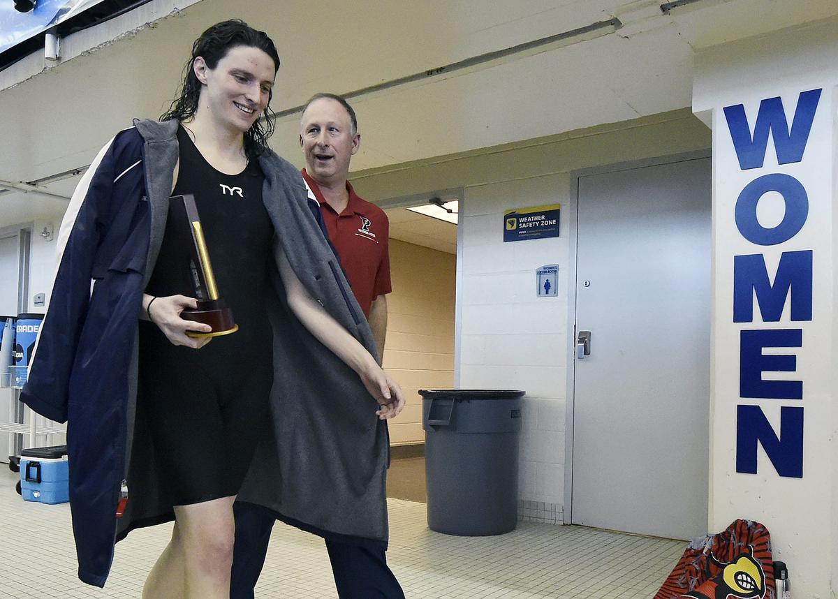  Lia Thomas, a competitive swimmer at the University of Pennsylvania, walks with her coach after winning an event in March 2022. Mike Comer/NCAA Photos via Getty Images 