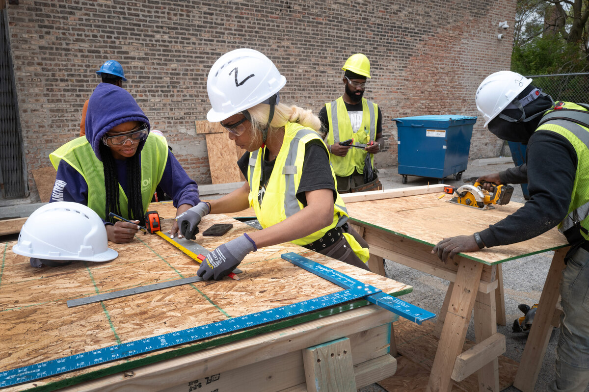  A class in construction skills at Revolution Workshop in Chicago, Illinois. Students from ages 18 to 40 get stipends to attend the 12-week program before moving on to apprenticeships in trades that face a worker shortage. Credit: Scott Olson/Getty Images