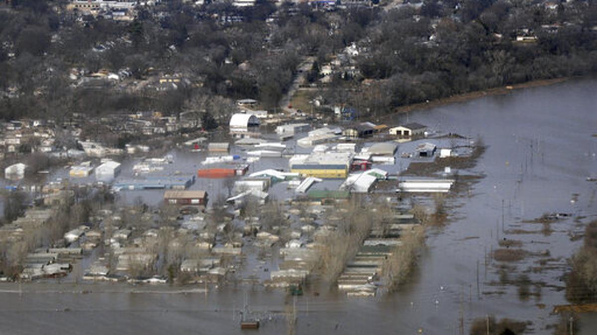 This March 17, 2019 photo released by the U.S. Air Force shows an aerial view of Areas surrounding Offutt Air Force Base affected by flood waters in Neb. Surging unexpectedly strong and up to 7 feet high, the Missouri River floodwaters that poured on to much the Nebraska air base that houses the U.S. Strategic Command overwhelmed the frantic sandbagging by troops and their scramble to save sensitive equipment, munitions and aircraft.